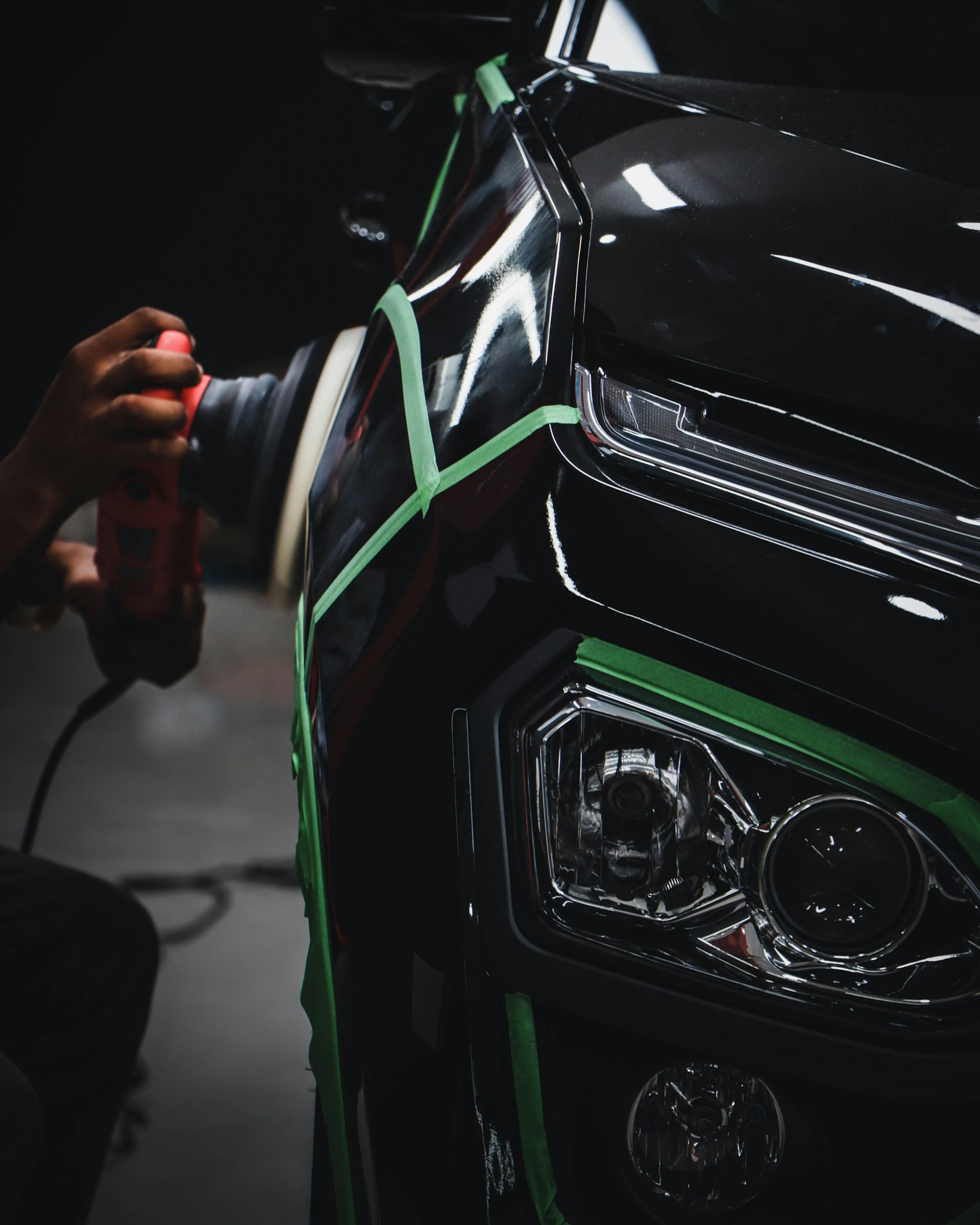A car being polished and detailed in the Spot On Panel Beaters workshop