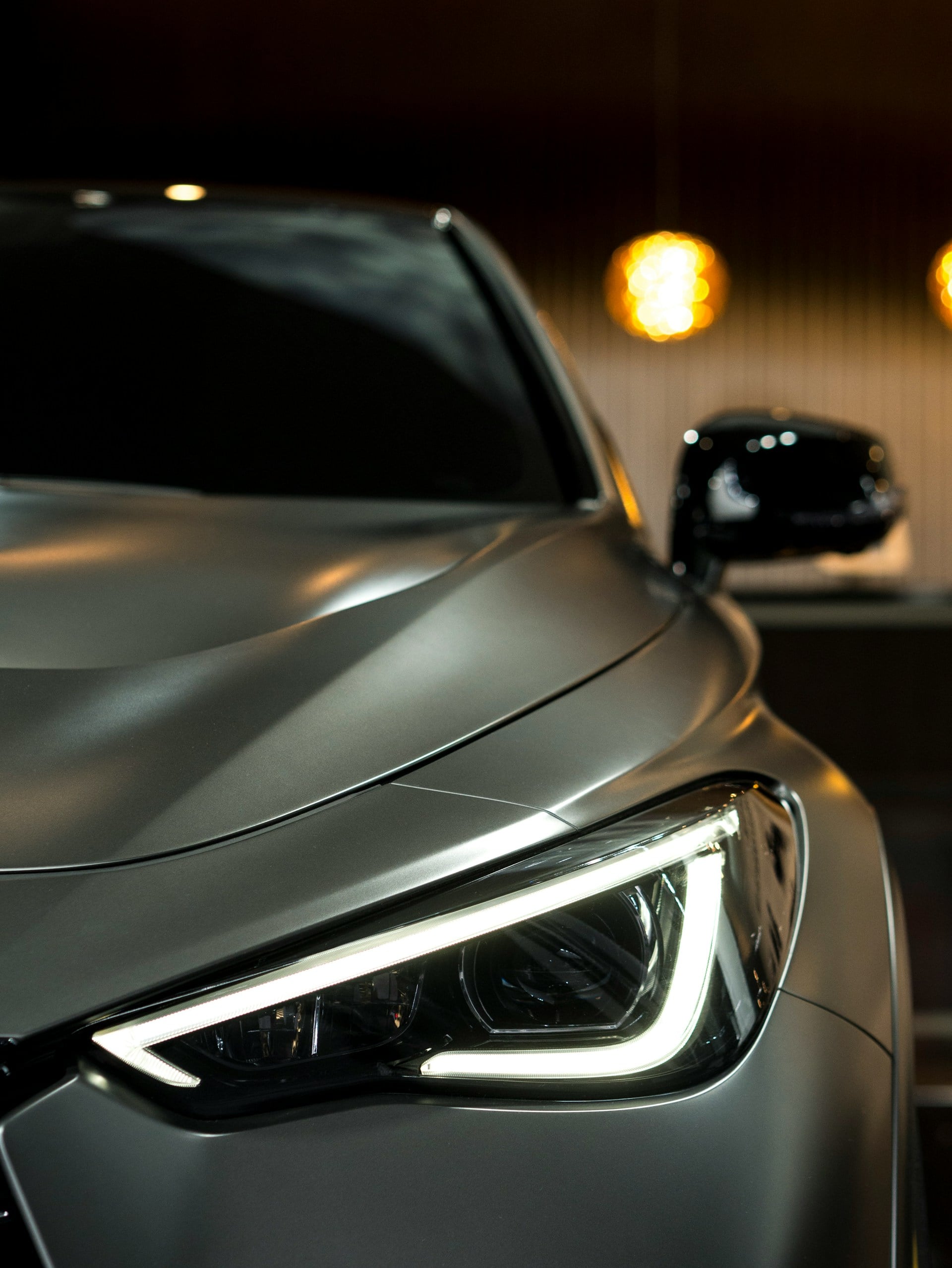 Close-up of a silver car headlight repaired by Spot On Panel Beaters